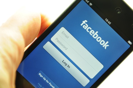 London, UK - 27 Feb, 2012: Social network concept with iPod and dedicated Facebook application