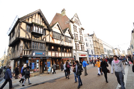 Oxford, England – November 12, 2011: Pedestrians and old architecture in central Oxford, England