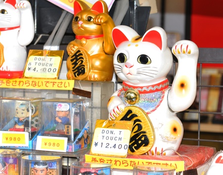 Tokyo, Japan - 31 December, 2011: Detail of Lucky Cat (Maneki Neko) at Sensoji Temple in Asakusa, Tokyo. It is a common Japanese sculpture which is believed to bring good luck to the owner.のeditorial素材