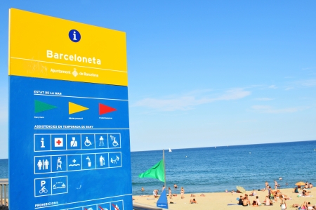 Barcelona, Spain - July 07, 2012: Crowds of tourists enjoying the sun on the beach in Barcelonaのeditorial素材