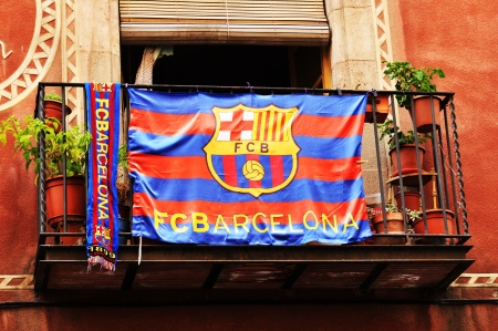 Barcelona, Spain - 07 July, 2012: Football Club Barcelona supporters flag hanging on the balcony of an old building  のeditorial素材