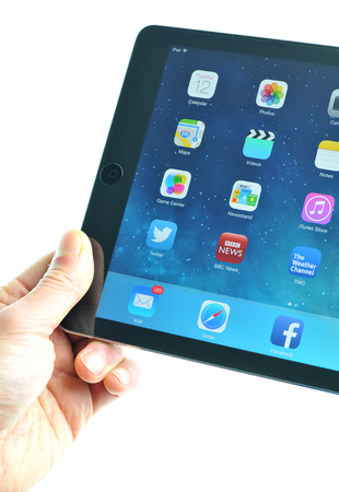 London, UK  December 13th, 3013 - User presenting the new iPad Air, the fifth generation iPad tablet computer designed, developed and marketed by Apple Inc   released on November 1, 2013のeditorial素材