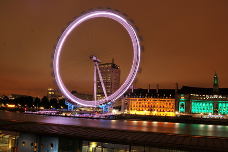 LONDON, UK - AUGUST 21, 2010: Panorama of London skyline with the famous London Eye at nightのeditorial素材