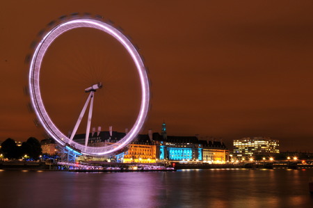 LONDON, UK - AUGUST 21, 2010: Panorama of London skyline with the famous London Eye at nightのeditorial素材