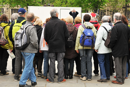PARIS, FRANCE - MARCH 29, 2011: Group of tourists prepare for sightseeing in Parisのeditorial素材