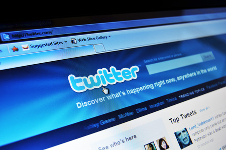 LONDON, UK - AUGUST 19, 2010: Close up of Twitter home page with mobile application on laptop...