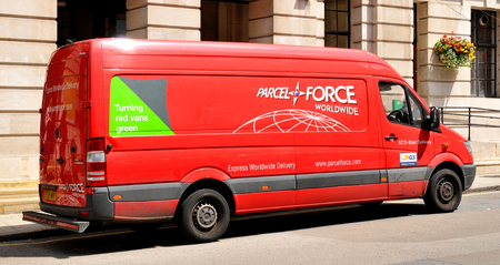 LONDON, UK - JULY 9, 2014: A red Parcelforce van parked in front of an old building in central...