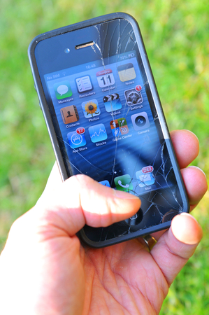 London, UK - June 12, 2015: Detail of broken iPhone screen.のeditorial素材