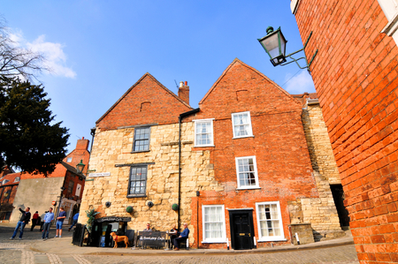 Lincoln, UK - April 9, 2015: Typical street view in the city centre of Lincoln, Lincolnshire, East Midlands, England.のeditorial素材