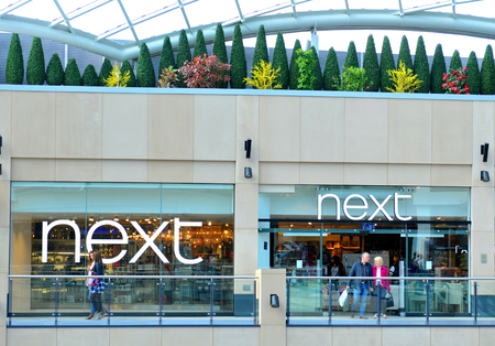 LEEDS, UK - APRIL 17, 2015: Next logo inside the Trinity shopping centre in Leeds, England.のeditorial素材
