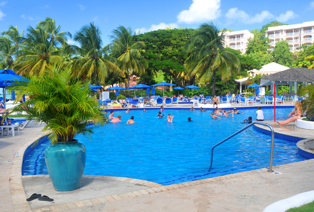 SAINT LUCIA, CARIBBEAN - DECEMBER 10, 2014:  Tourists relax by the pool in exotic resort in Saint Lucia, Caribbeanのeditorial素材