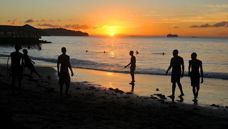 SAINT LUCIA, CARIBBEAN - DECEMBER 10, 2014: Silhouettes of people at sunset on the beach of Saint Luciaのeditorial素材