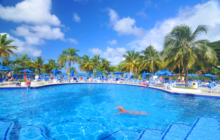 SAINT LUCIA, CARIBBEAN - DECEMBER 10, 2014:  Tourists relax by the pool in exotic resort in Saint Lucia, Caribbeanのeditorial素材