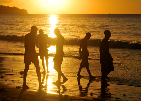 SAINT LUCIA, CARIBBEAN - DECEMBER 10, 2014: Silhouettes of people at sunset on the beach of Saint Luciaのeditorial素材