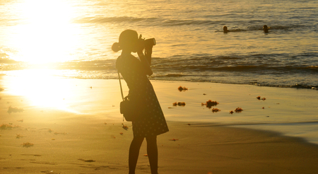 SAINT LUCIA, CARIBBEAN - DECEMBER 10, 2014: Female photographer at sunset in Caribbeanのeditorial素材