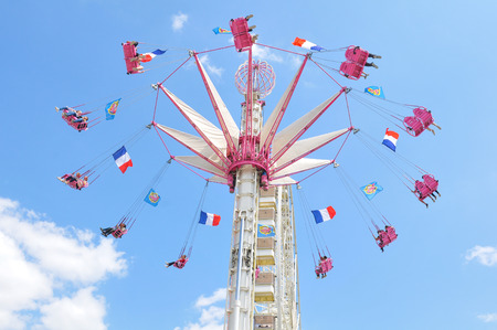 Paris, France - July 9, 2015: Tourists have fun in ferris wheel in amusement park in Jardin des Tuileries, Paris, Franceのeditorial素材