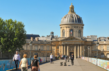 Paris, France - July 9, 2015: Pedestrians cross the Ponts des Arts to BibliothÃ¨que Mazarine in Paris.のeditorial素材