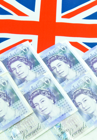 British pound concept  with currency and UK flagのeditorial素材