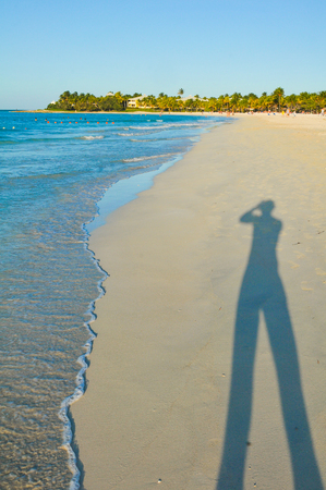 Shadow of tourist taking pictures in Varadero, Cubaの写真素材