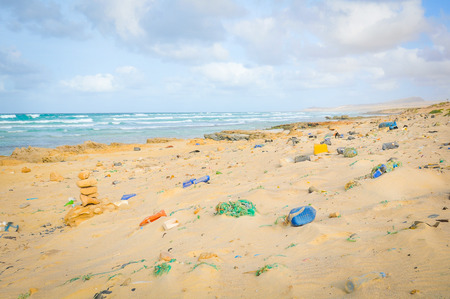 Pollution concept with detail of plastic bottles on the beachの写真素材