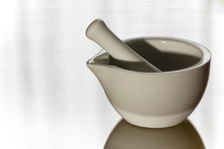 White ceramic mortar on a glass plateの写真素材