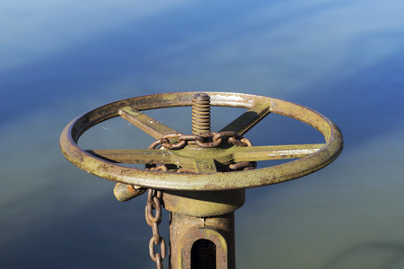 rusty wheel by the pondの写真素材