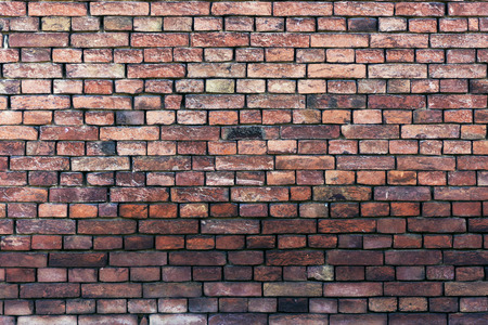 Old brick wall damaged with shadowの写真素材