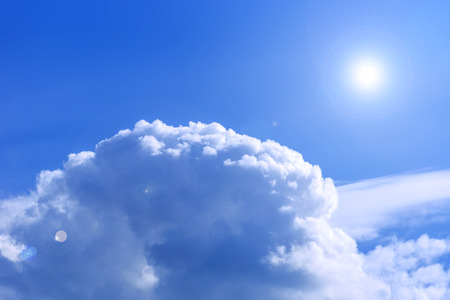 Sky view above the clouds with lens flareの写真素材