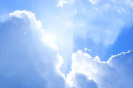 sky with clouds and sun showing throughの写真素材