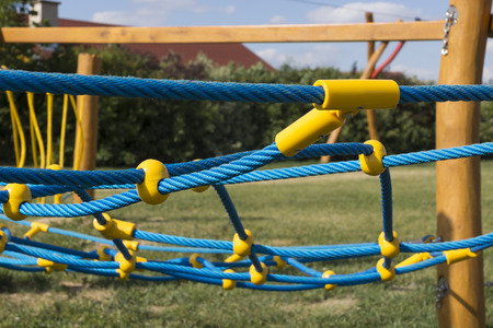 yellow and blue rope-climbing frame in the playgroundの写真素材