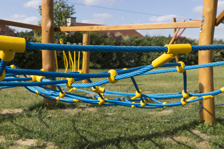 yellow and blue rope-climbing frame in the playgroundの写真素材