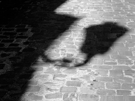 shadow of a lamppost on paved street  Photo in black and white の写真素材