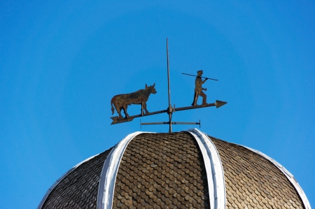 weather vane against blue skyの写真素材