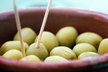 olives with toothpick in a clay potの写真素材