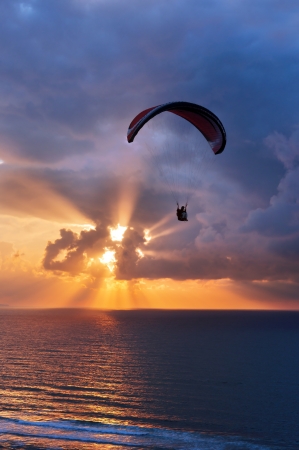 paragliding at sunset on sea with sun beams. Sopelana, Basque Country, Spainの写真素材