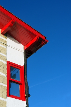 House facade with red roof and window against blue sky in Puerto Viejo, Getxo.の写真素材