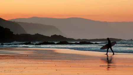 surfer on beach shore at sunsetの写真素材