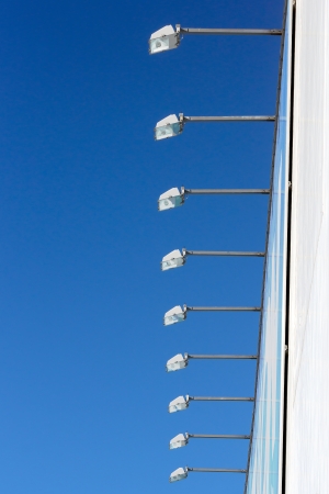spotlights against blue sky on wallの写真素材