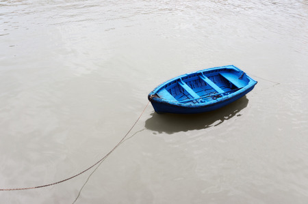 colorful and solitary fishing boat on waterの写真素材