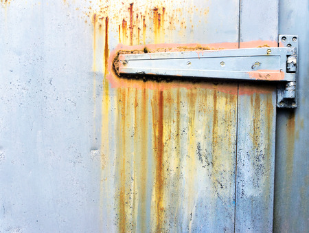 Rusty metallic hinge on a doorの写真素材