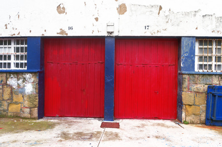 two garages with red roller shuttersの写真素材