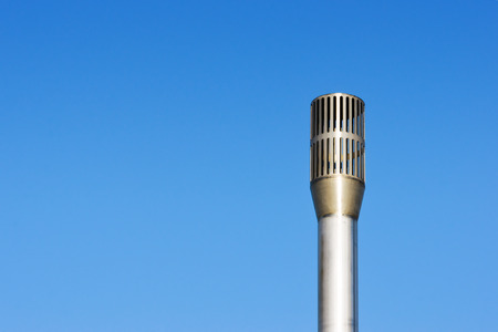 metallic chimney against blue skyの写真素材