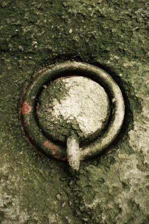 metallic and rusty mooring ring on dockの写真素材