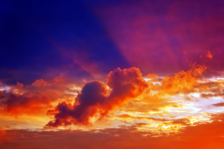 cloudscape with clouds at sunset with sun rays