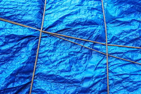 texture of plastic waterproof tarpaulin with ropeの写真素材