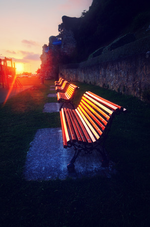benches at sunset reflecting the sunlightの写真素材