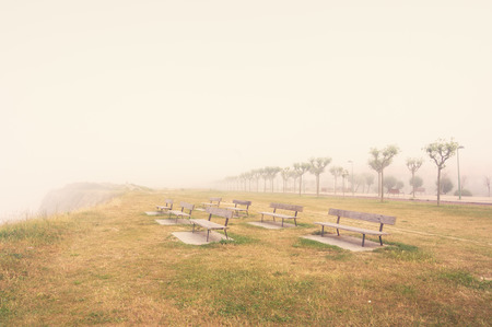 benches on a foggy cliff and vintage filter effectの写真素材