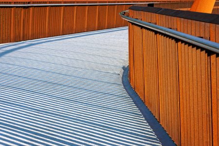 pedestrian bridge with handrail and shadowsの写真素材