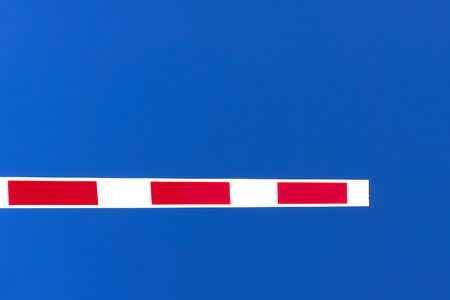 closed security barrier against blue skyの写真素材