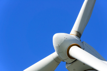 closeup of wind turbine against blue skyの写真素材